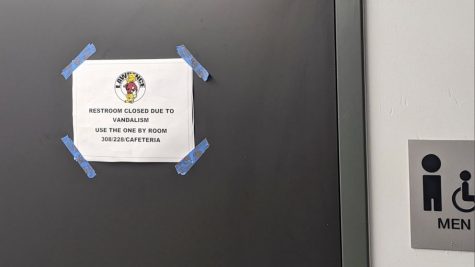 A  sign posted on the restroom door at Lawrence High School in Lawernce, Kansas states that the restroom is closed due to Vandalism